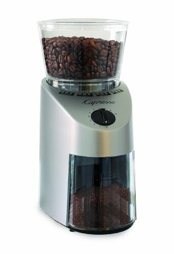 Coffee grinder with coffee beans and ground coffee.