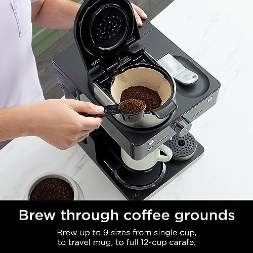 Person scooping coffee grounds into a coffee maker