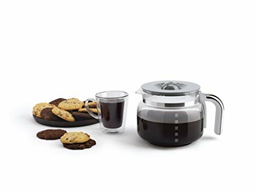 Coffee pot, glass mug, and plate of cookies.