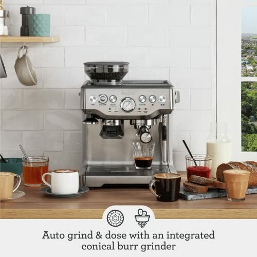 Espresso machine with coffee cups and bread on a countertop.