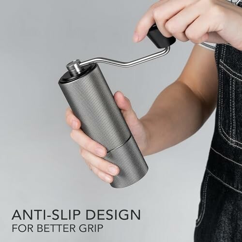 Person using a manual coffee grinder with anti-slip design.